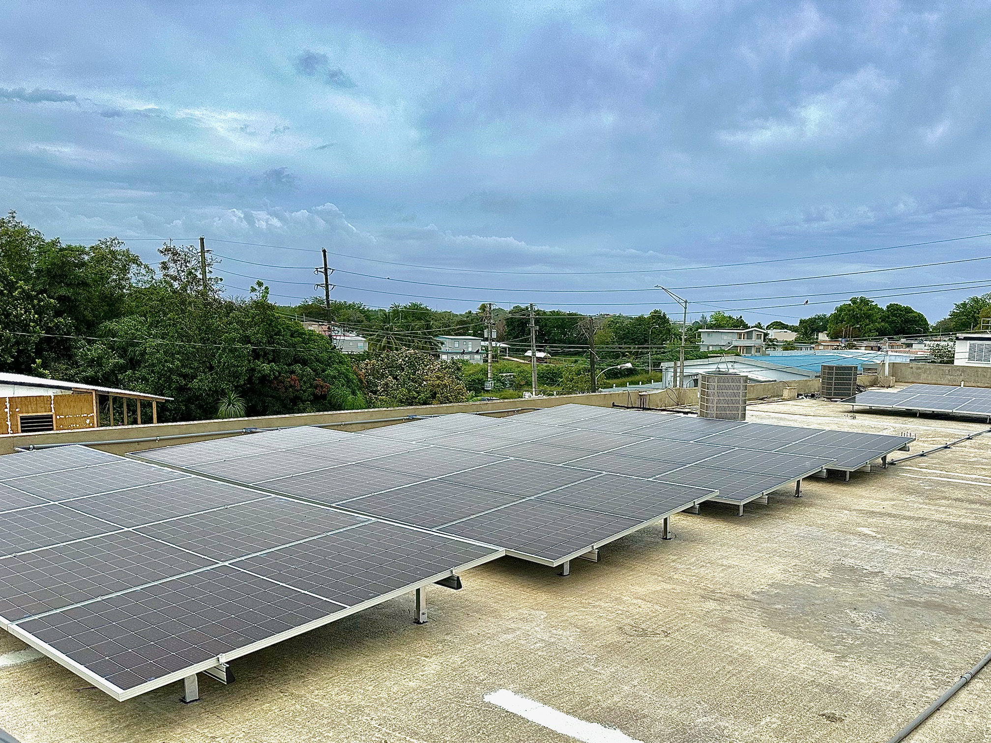 Close-up of black solar panels against a blue sky